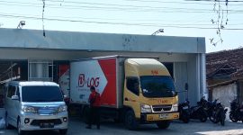 Keterangan gambar kendaraan box kargo tampak menurunkan barang ke bangunan yang diduga kuat akan beroperasi sebagai Alfamart